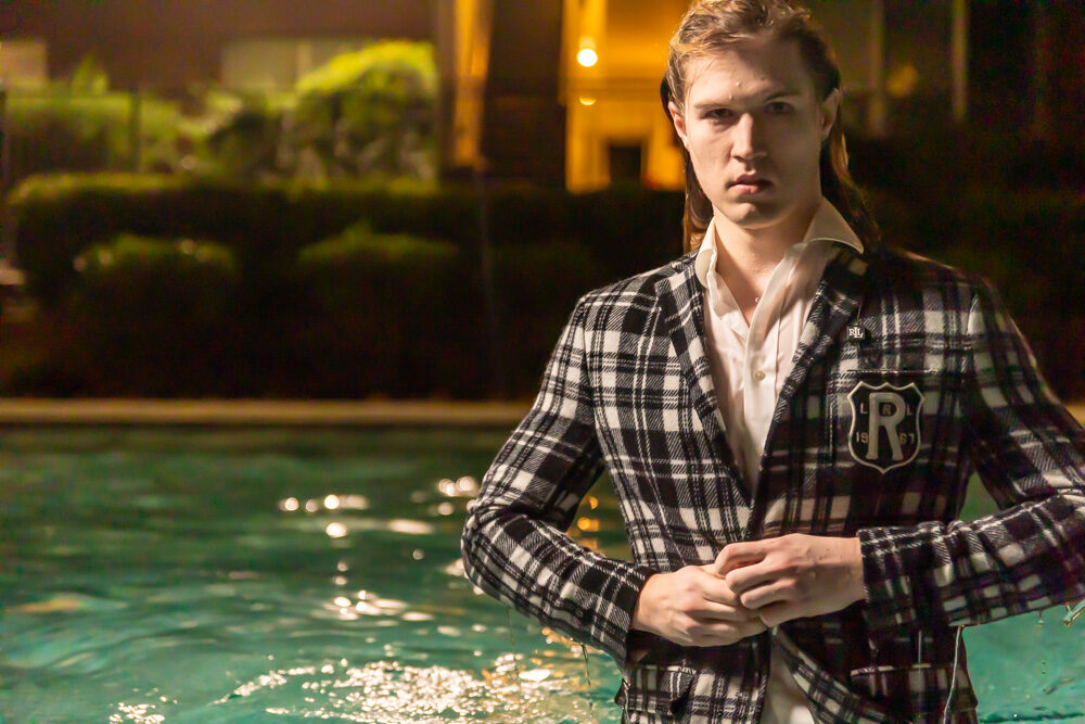 Commercial fashion portrait, plaid blazer at poolside